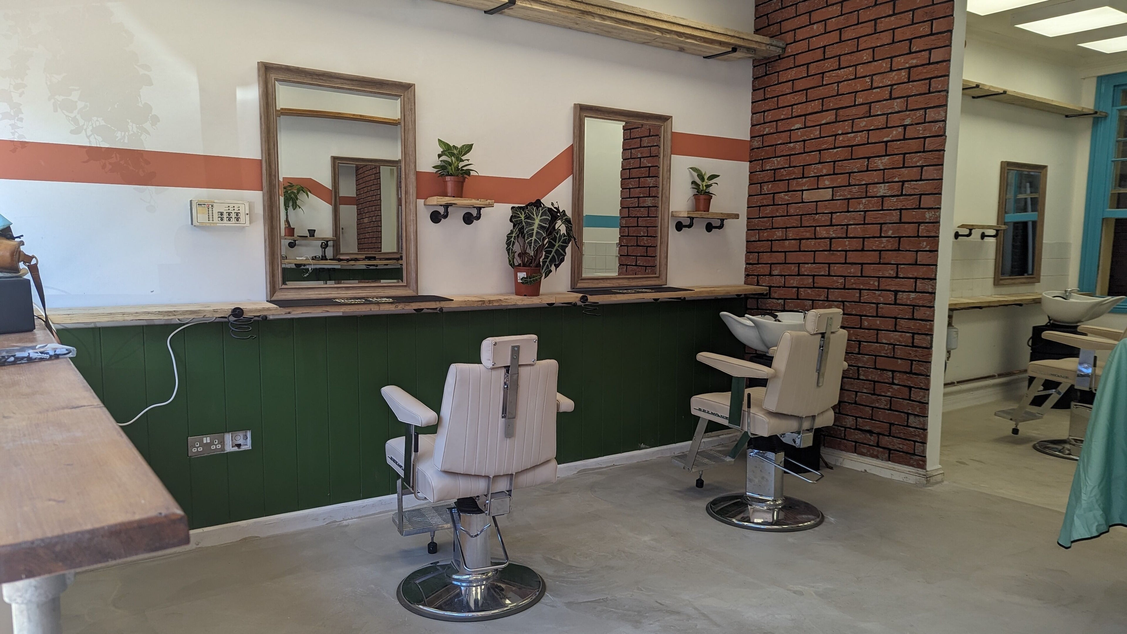 Modern salon interior at dooo Hub - Old Market (Gender Free), Bristol, England, GB with chic styling chairs.