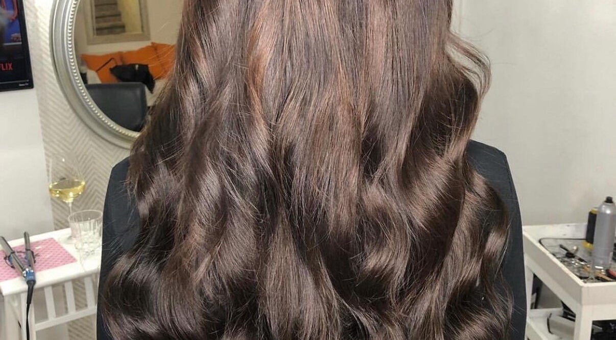 Cheveux ondulés et brillants réalisés à Vivi Extension, Mirabel, Québec, CA, dans un cadre élégant.