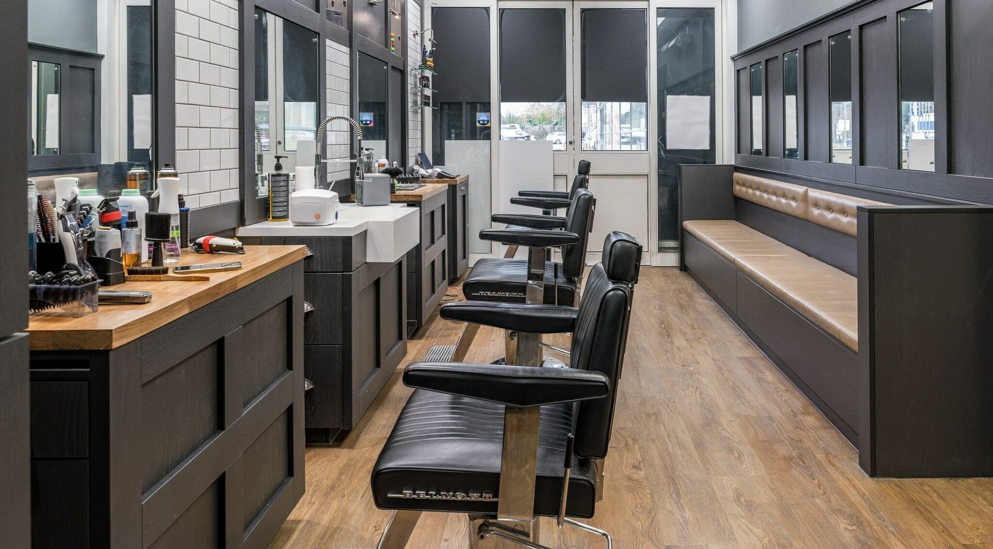 Gould Barbers London (Barnet) interior with leather chairs and wooden counters, London, England, GB.