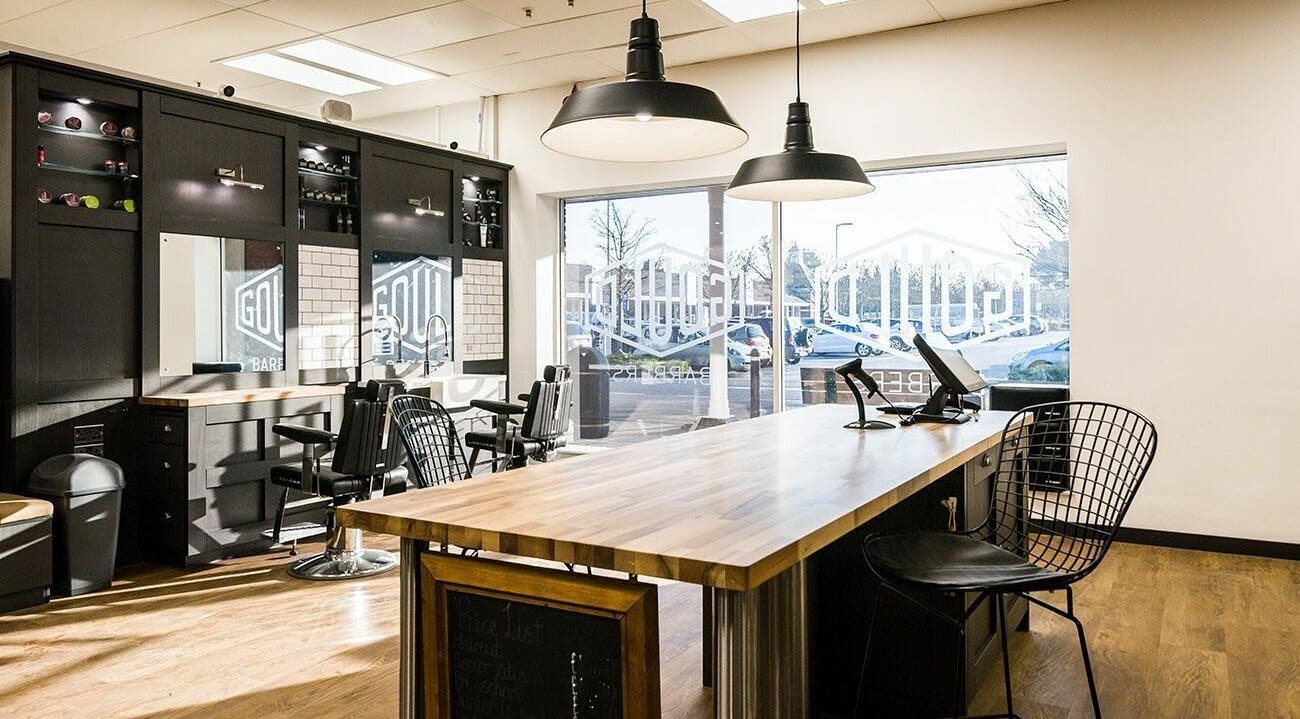 Modern interior of Gould Barbers Bournemouth in Bournemouth, England, GB with stylish black decor and spacious seating.