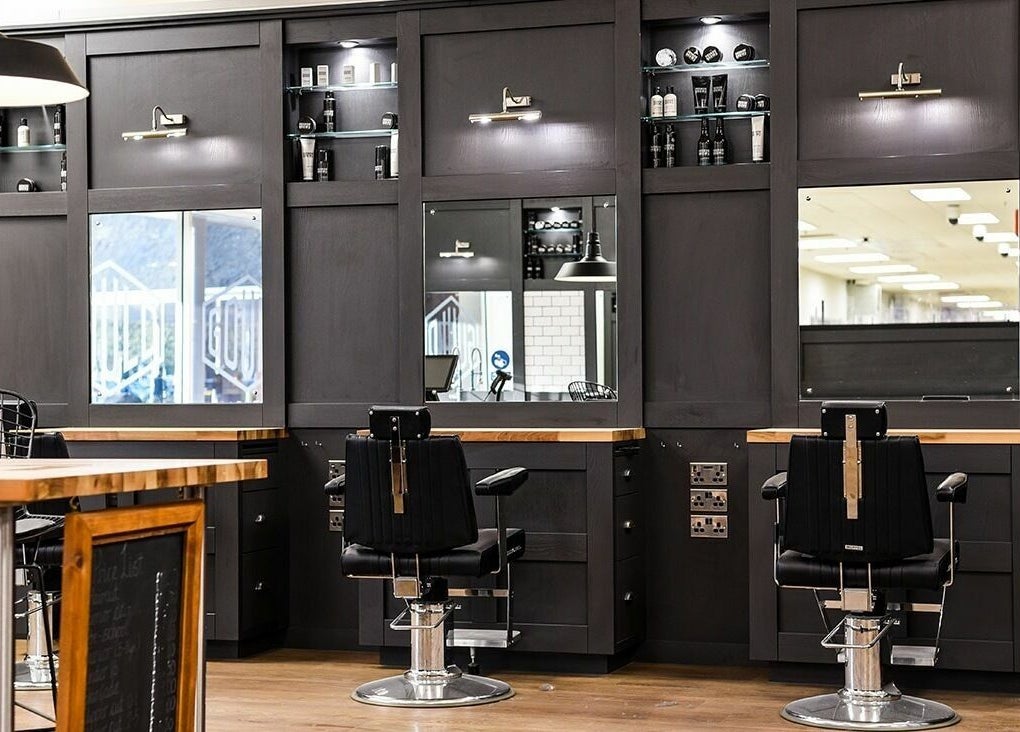 Interior of Gould Barbers Bournemouth featuring stylish chairs and mirrors, Bournemouth, England, GB.