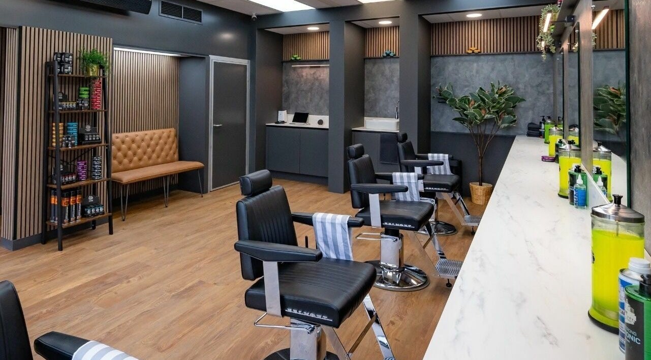 Modern interior of Gould Barbers Norwich in Norwich, England, GB with sleek chairs and stylish decor.