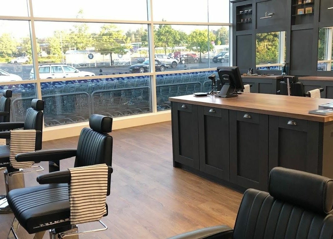 Modern interior of Gould Barbers Mansfield in Mansfield, England, GB featuring sleek barber chairs and counter.
