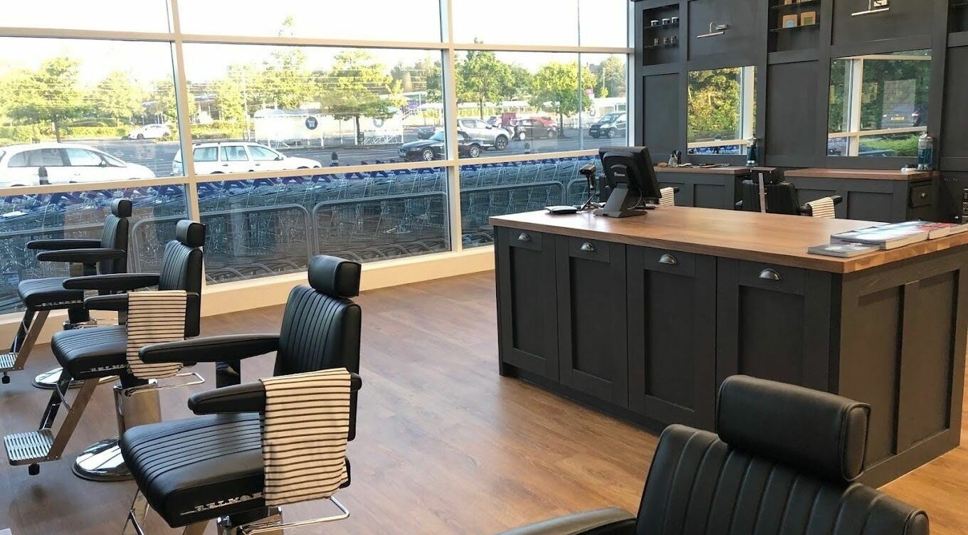 Modern interior of Gould Barbers Mansfield in Mansfield, England, GB featuring sleek barber chairs and counter.