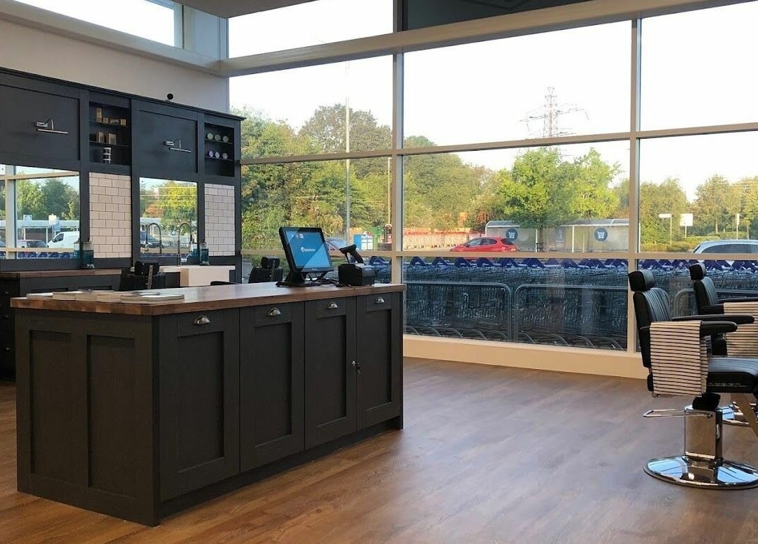 Modern interior of Gould Barbers Mansfield in Mansfield, England, GB with stylish chairs and natural light.