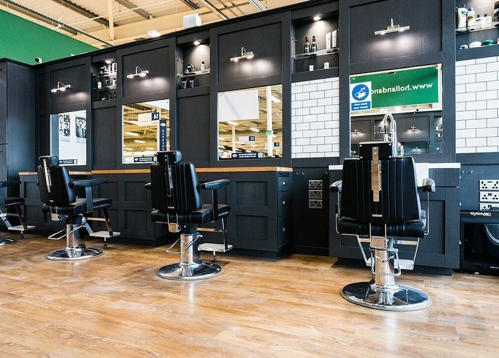 Modern barber chairs in Gould Barbers Mansfield, Mansfield, England, GB with sleek black cabinetry.