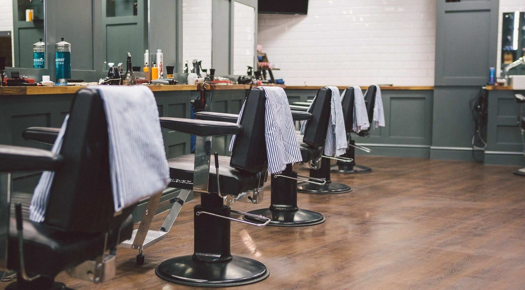 Interior view of Gould Barbers Chesterfield, sleek barber chairs lined up in Chesterfield, England, GB.