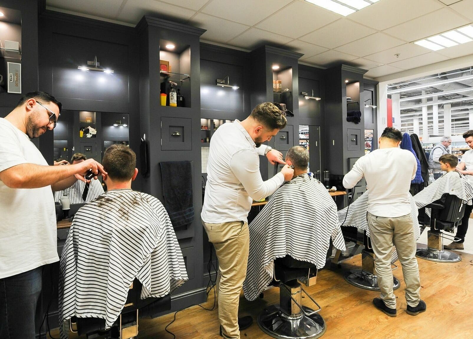 Professional barbers in action at Gould Barbers Chesterfield, Chesterfield, England, GB.