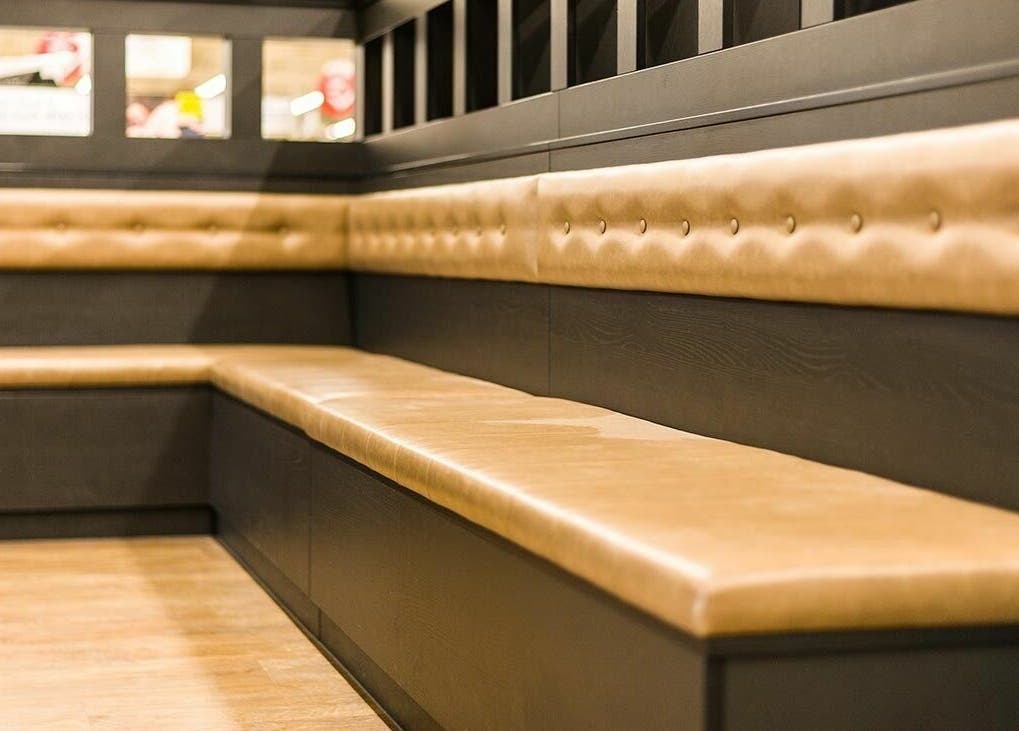 Comfortable seating at Gould Barbers Basildon (Pitsea), Basildon, England, GB with stylish bench design.