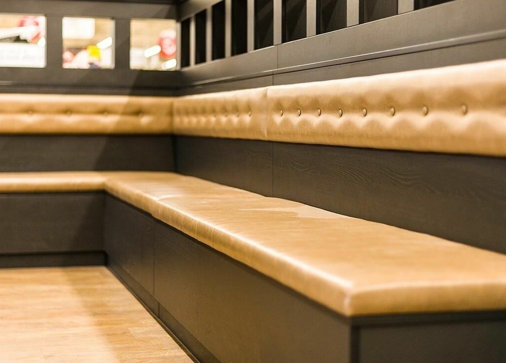 Comfortable seating at Gould Barbers Basildon (Pitsea), Basildon, England, GB with stylish bench design.