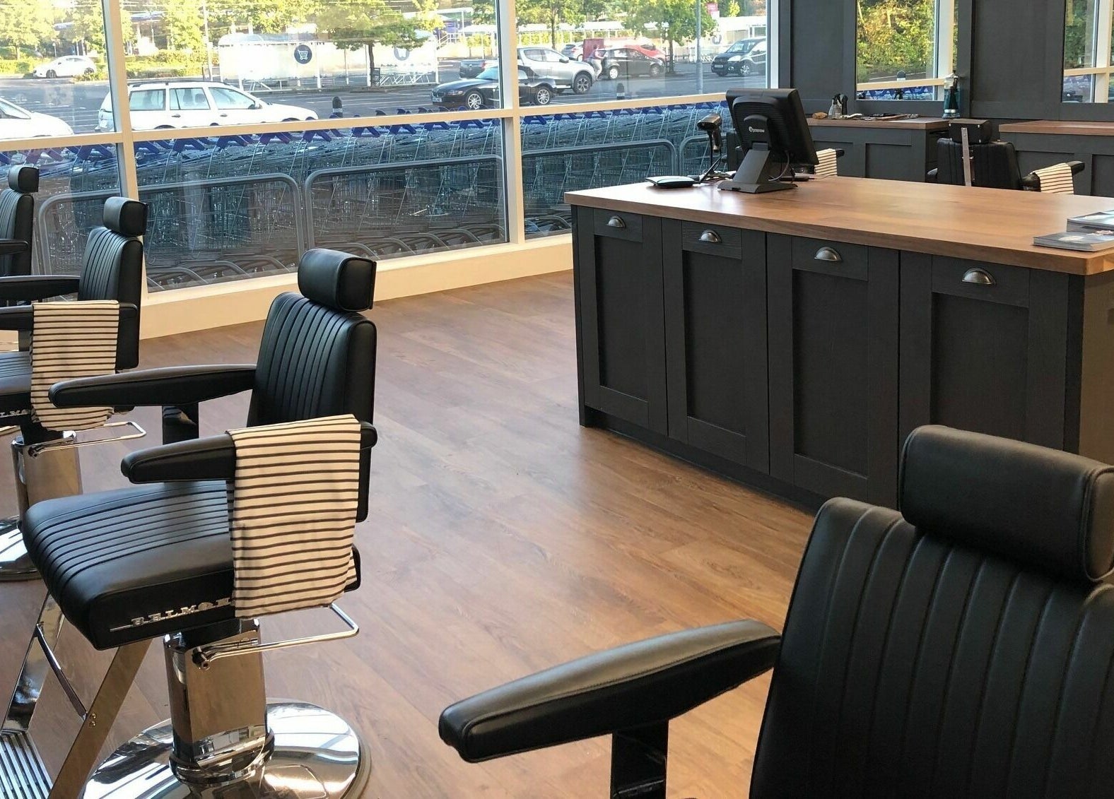 Modern barber chairs at Gould Barbers Basildon (Pitsea) in Basildon, England, GB, offering stylish grooming services.