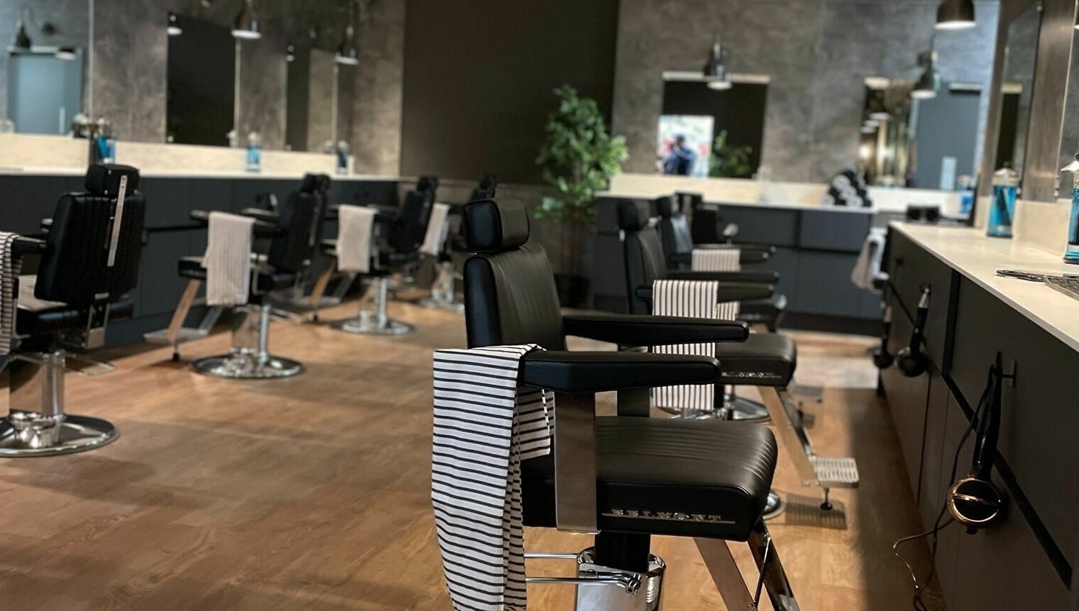 Interior view of Gould Barbers Cambridge (Bar Hill), showcasing sleek black barber chairs in Bar Hill, England, GB.