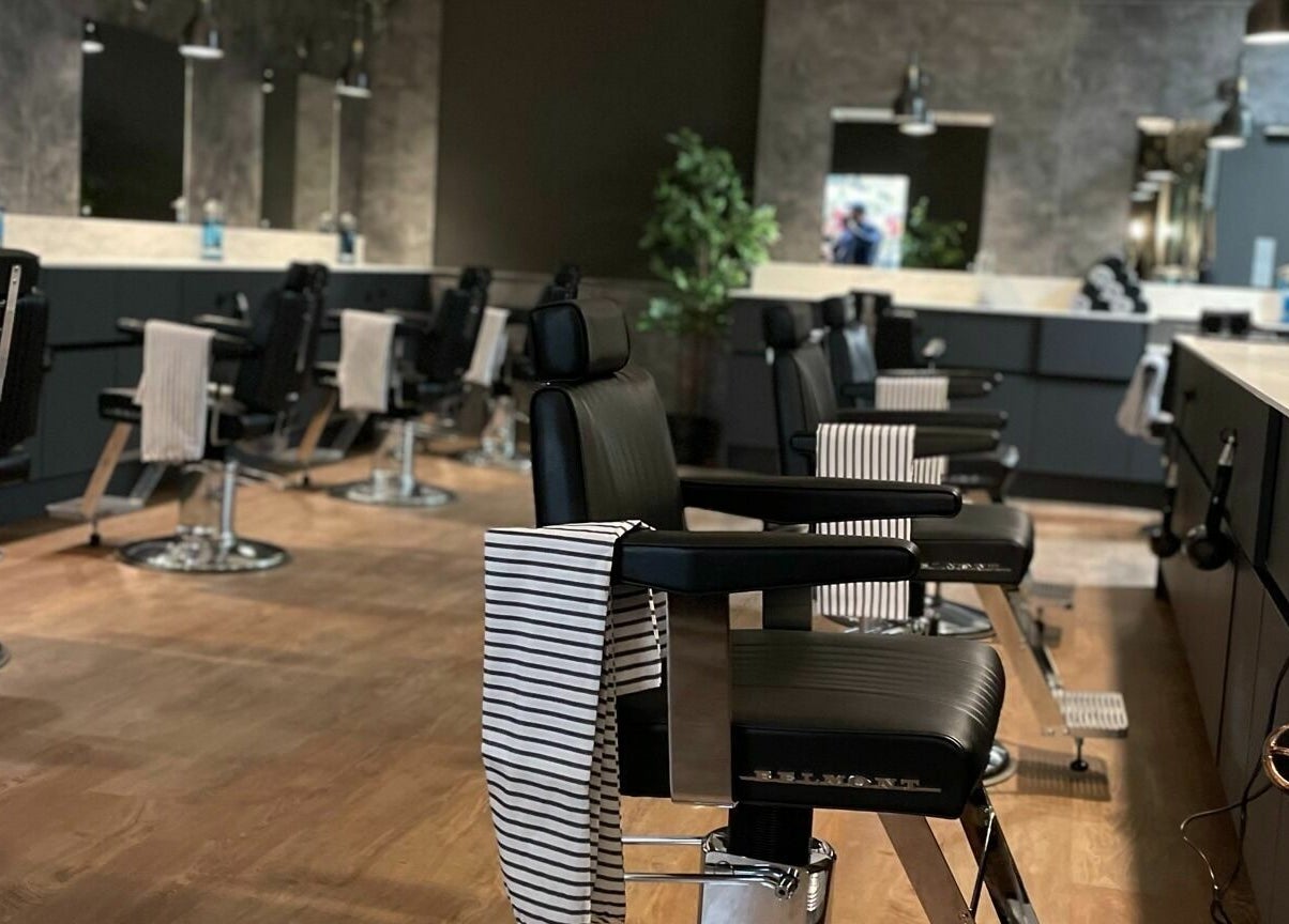 Interior view of Gould Barbers Cambridge (Bar Hill), showcasing sleek black barber chairs in Bar Hill, England, GB.