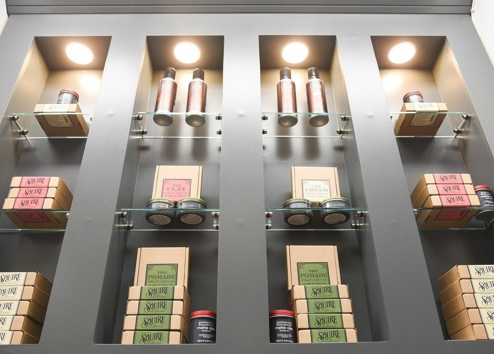 Modern shelves with grooming products at Gould Barbers Cambridge (Bar Hill), Bar Hill, England, GB.