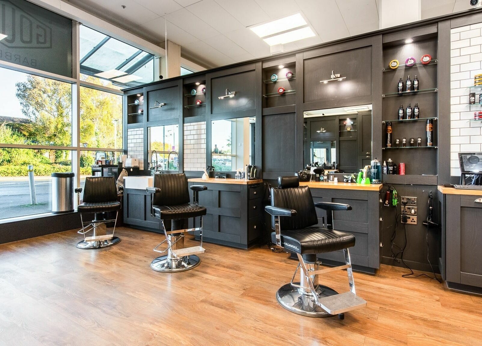 Modern barber chairs at Gould Barbers Newbury, Newbury, England, GB, showcasing a stylish and inviting interior.