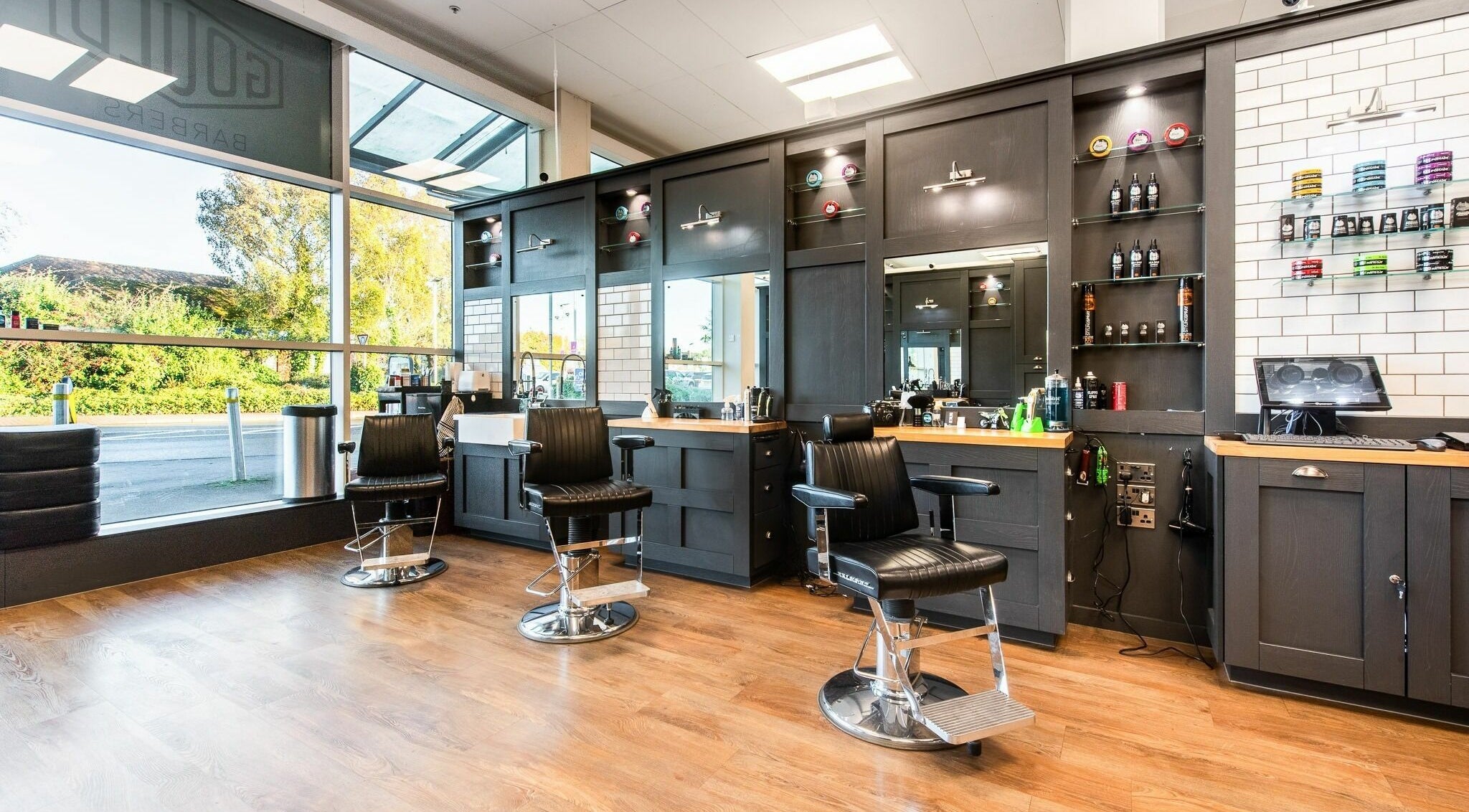 Modern barber chairs at Gould Barbers Newbury, Newbury, England, GB, showcasing a stylish and inviting interior.