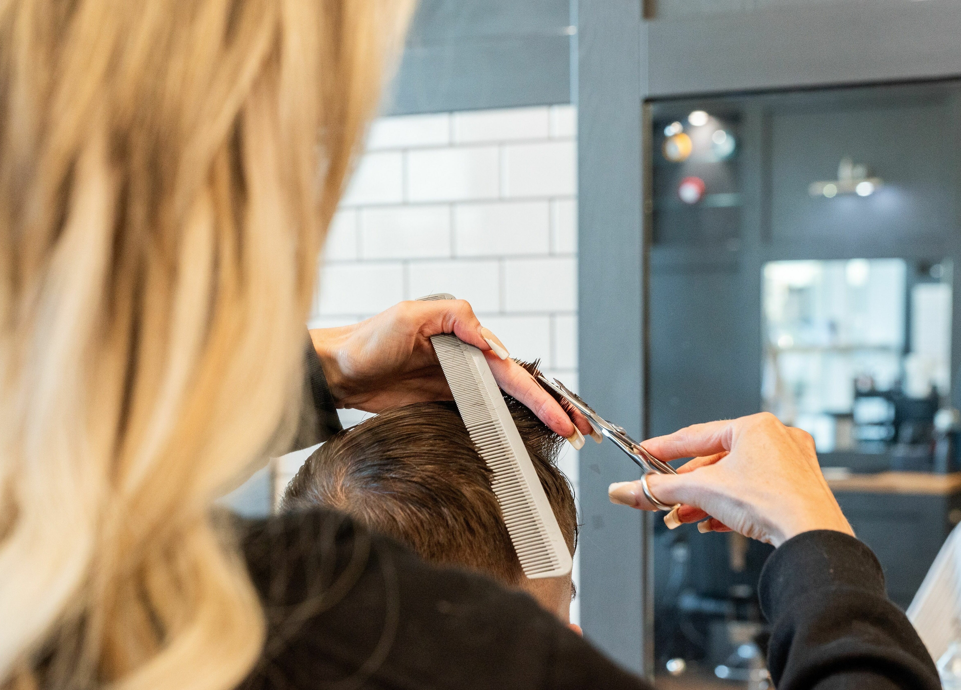 Expert styling at Gould Barbers Newbury, Newbury, England, GB, capturing detailed grooming process.