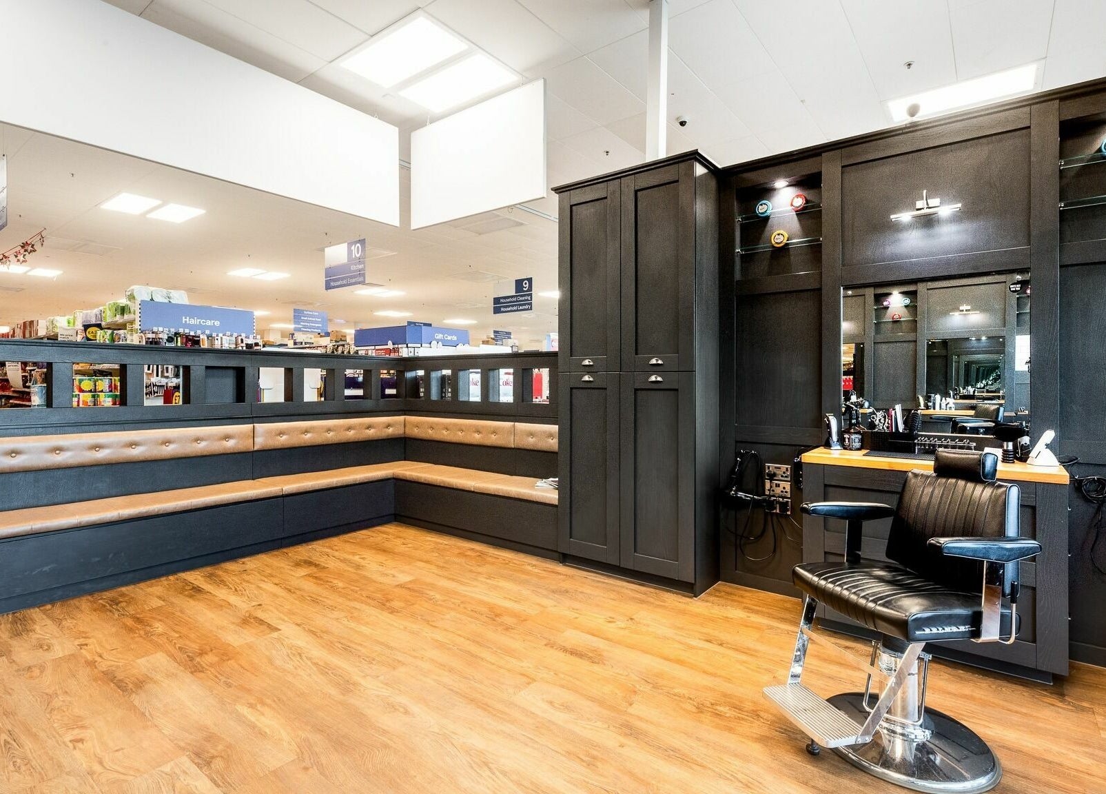 Sleek interior of Gould Barbers Newbury in Newbury, England, GB, featuring a stylish barber chair and spacious seating.