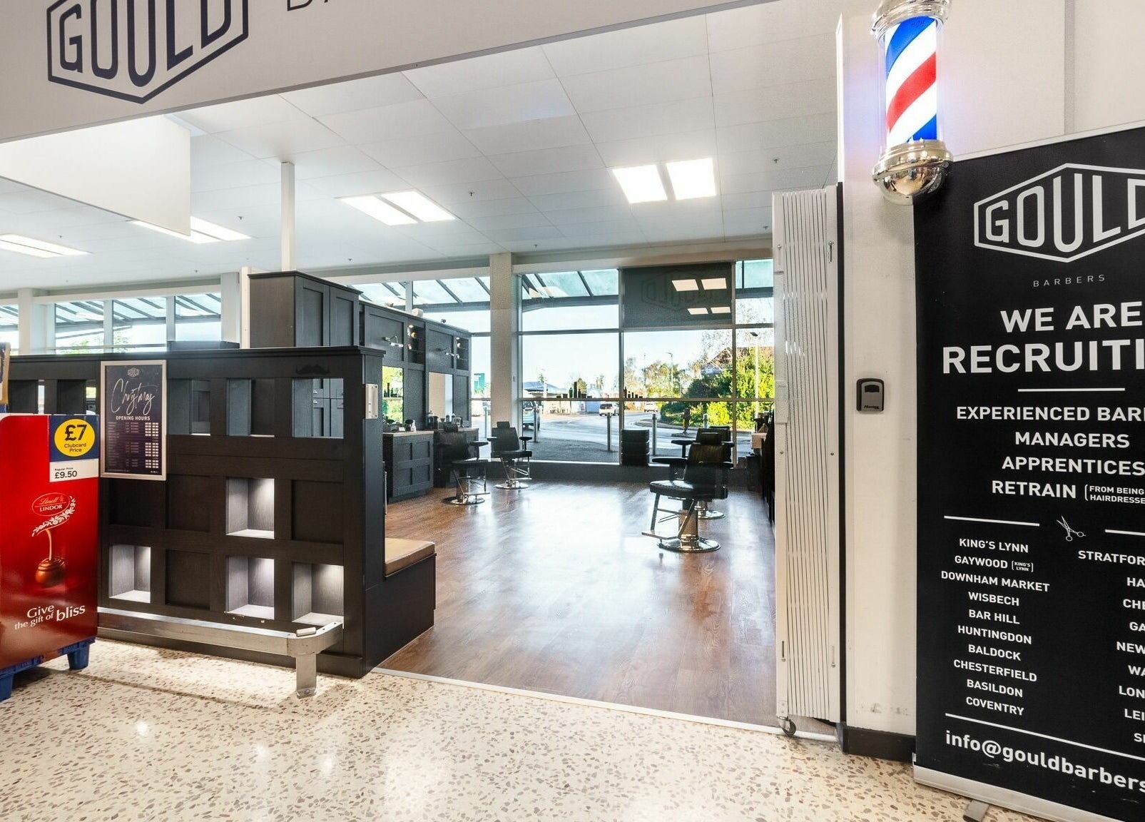 Interior of Gould Barbers Newbury in Newbury, England, GB with stylish chairs and modern decor.