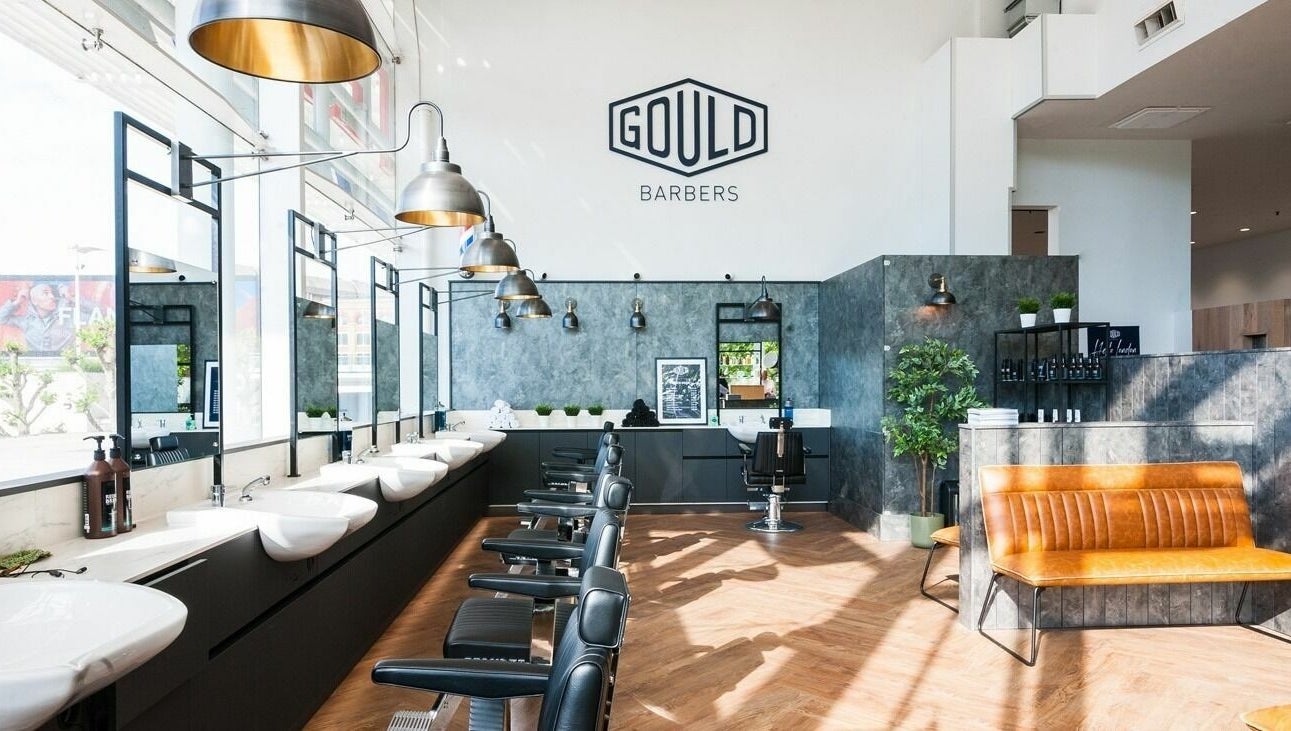 Modern interior of Gould Barbers Horsham with sleek chairs and lighting, located in Horsham, England, GB.