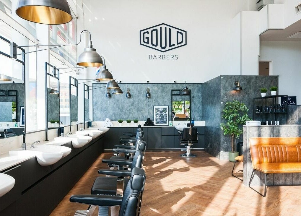 Modern interior of Gould Barbers Horsham with sleek chairs and lighting, located in Horsham, England, GB.