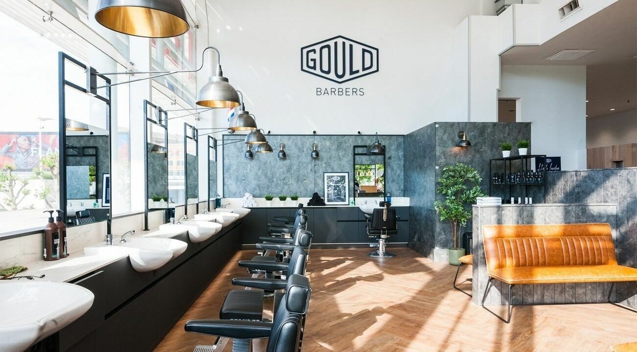 Modern interior of Gould Barbers Horsham with sleek chairs and lighting, located in Horsham, England, GB.