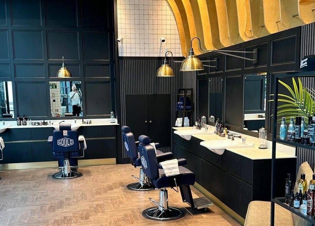 Elegant interior of Gould Barbers Horsham in Horsham, England, GB, featuring modern barber chairs and stylish decor.