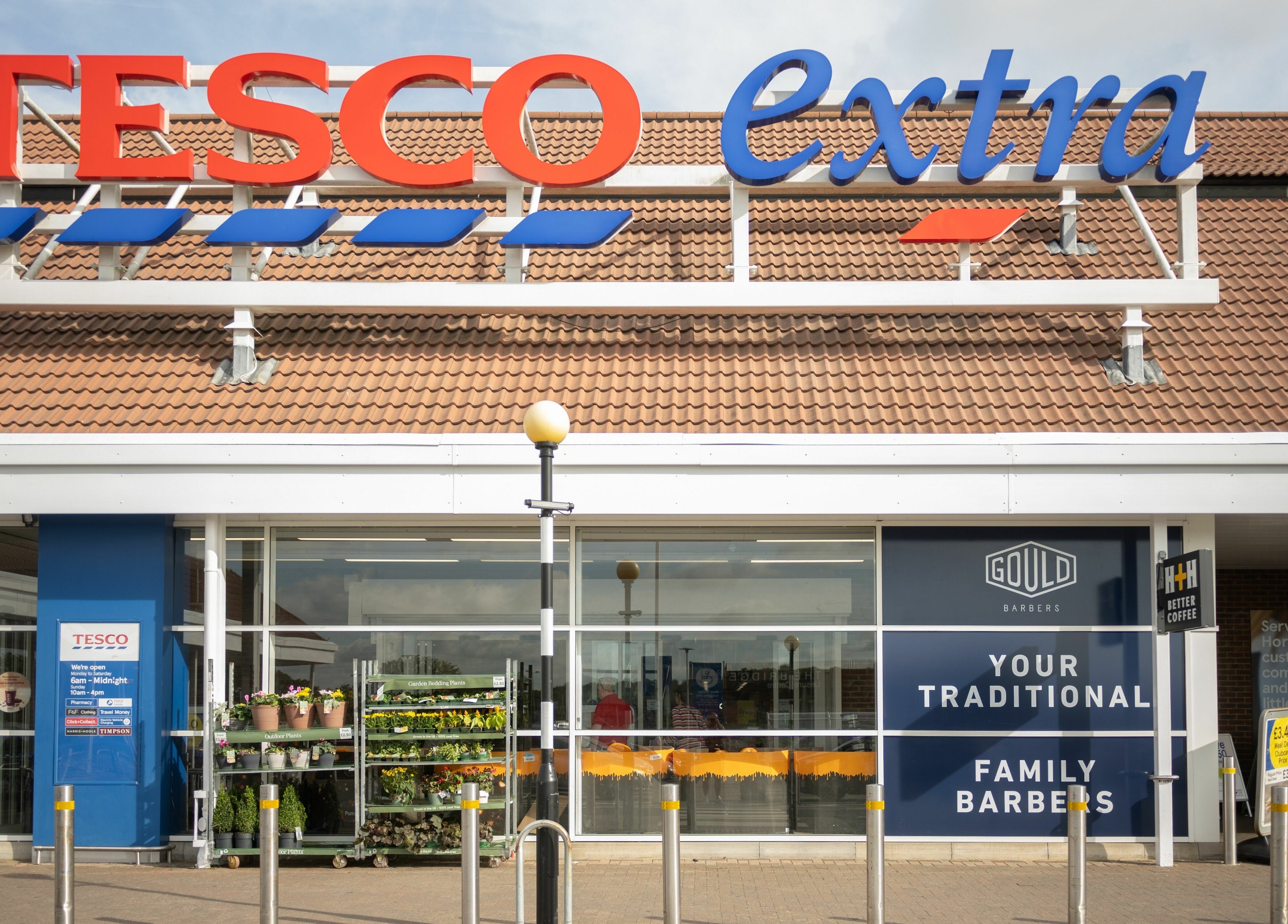 Entrance of Gould Barbers Horsham at Tesco Extra, Horsham, England, GB.
