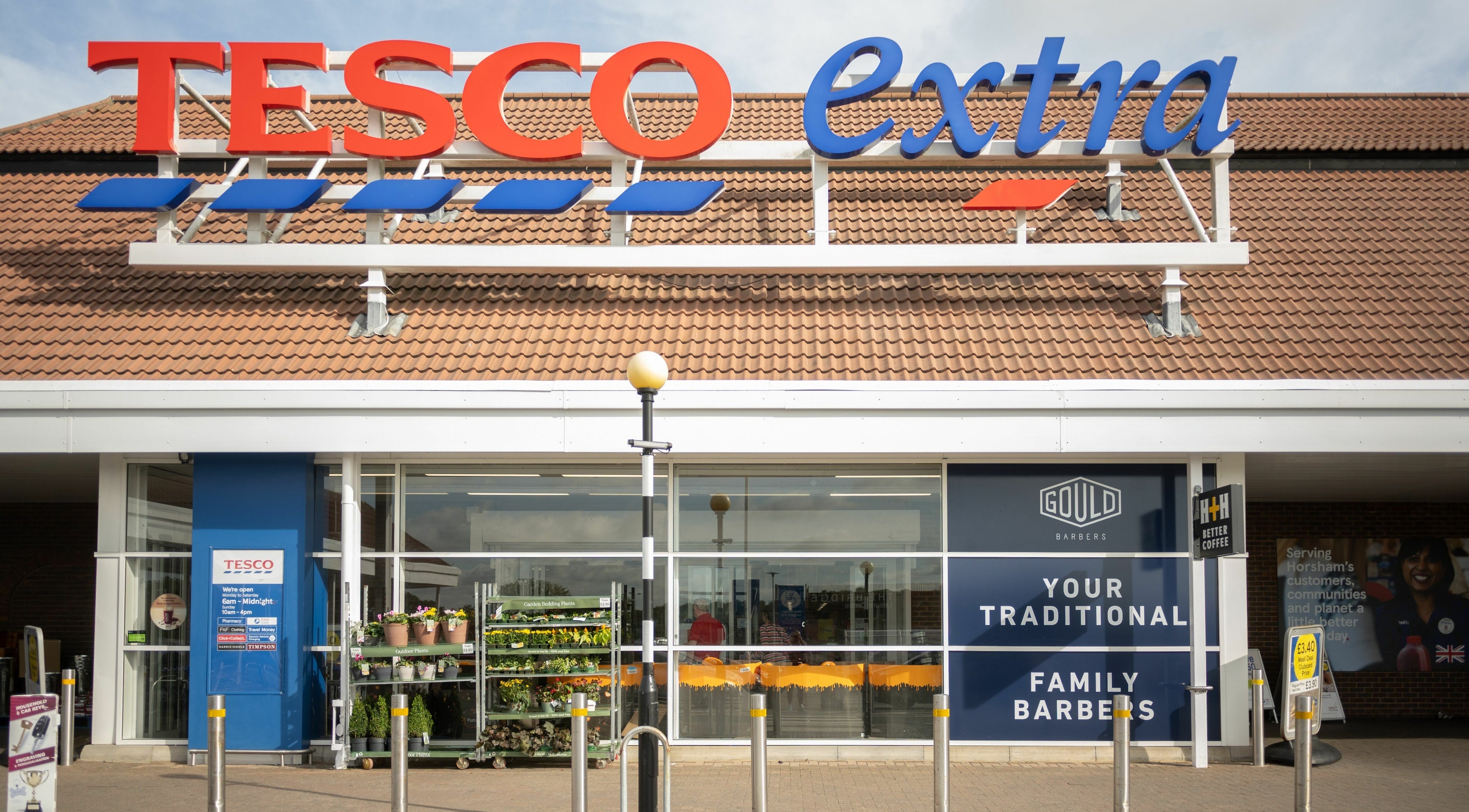 Entrance of Gould Barbers Horsham at Tesco Extra, Horsham, England, GB.