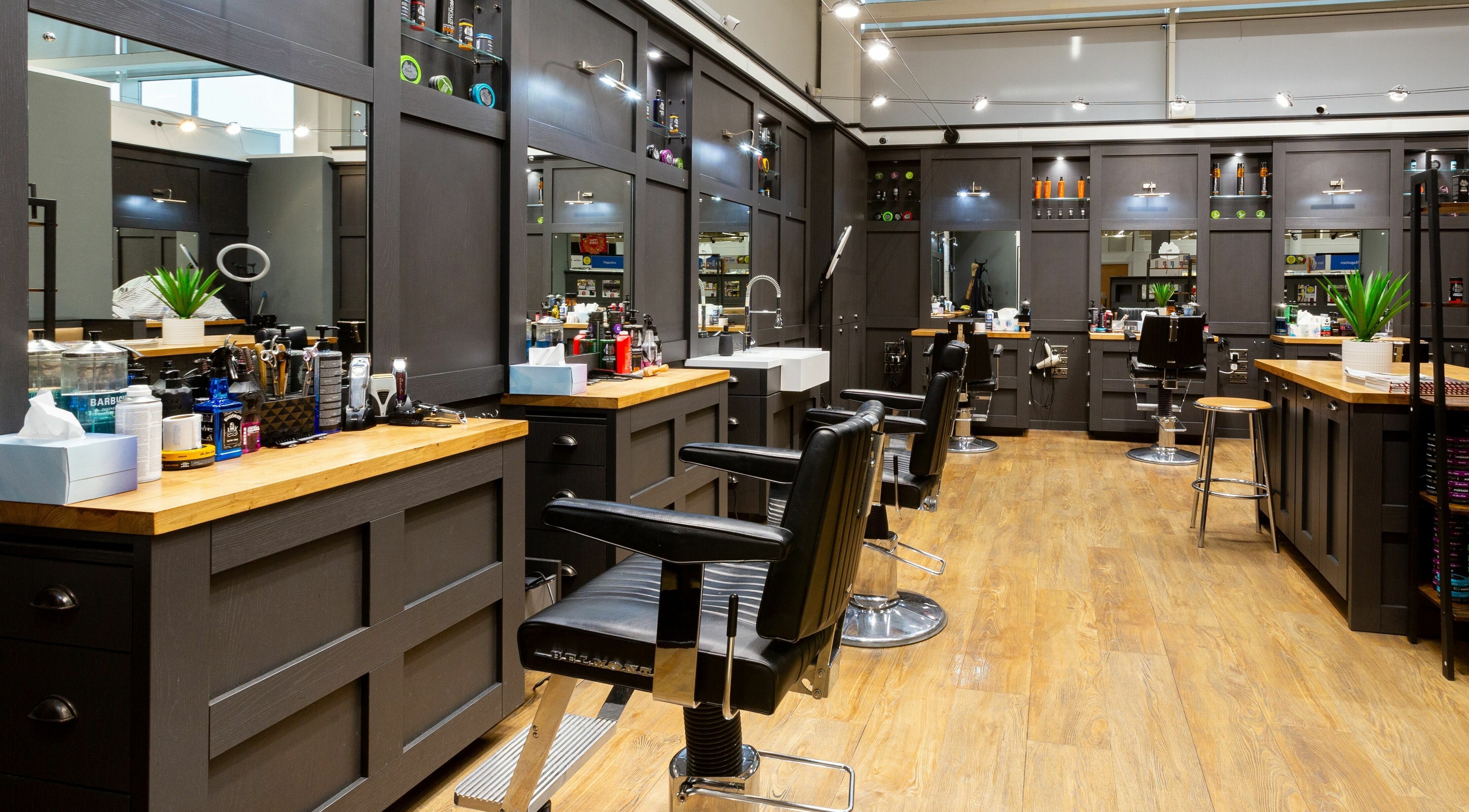 Modern interior of Gould Barbers Slough with stylish chairs and grooming tools in Slough, England, GB.