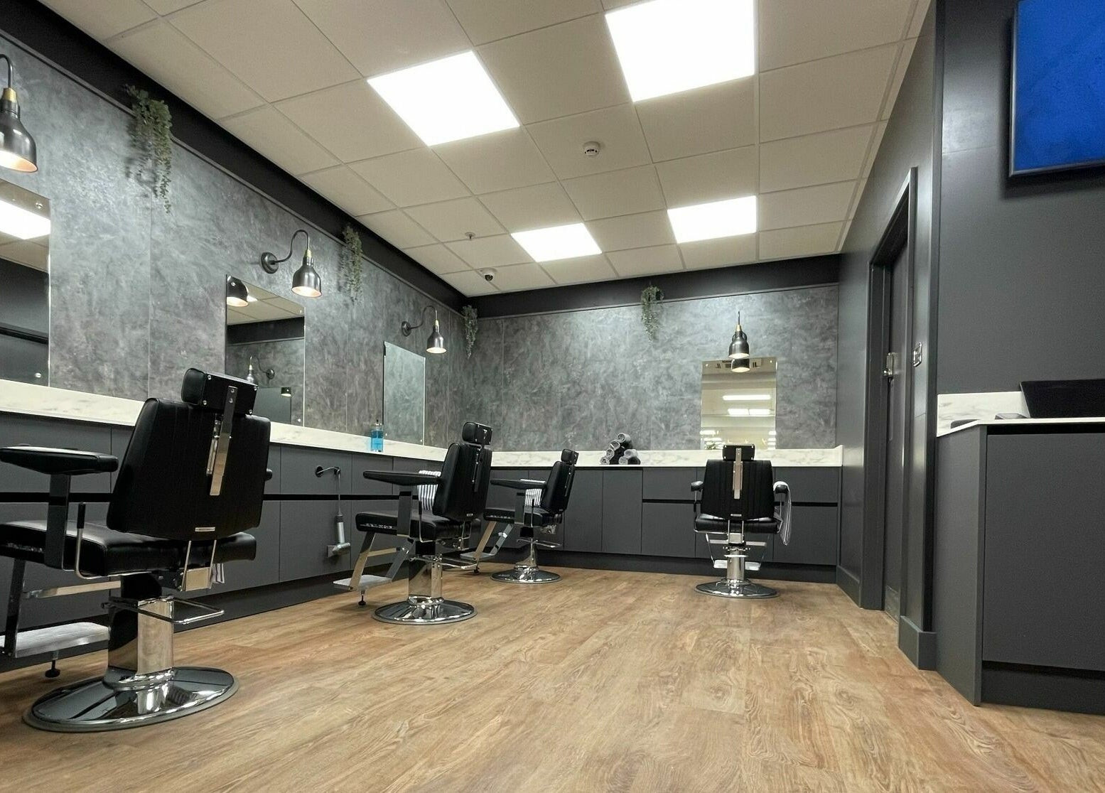 Stylish interior of Gould Barbers Colchester in Colchester, England, GB, showcasing modern barber chairs.
