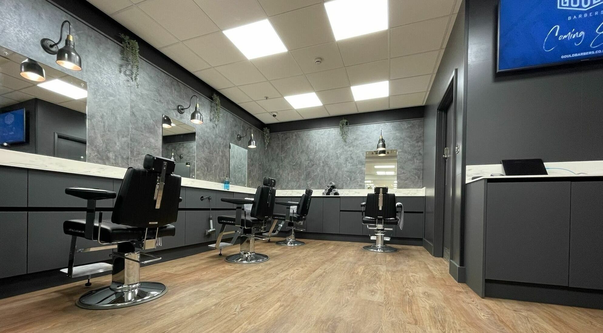 Stylish interior of Gould Barbers Colchester in Colchester, England, GB, showcasing modern barber chairs.