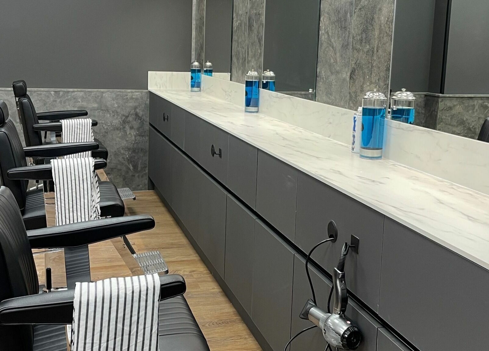 Sleek interior of Gould Barbers Colchester, featuring modern chairs and mirrors in Colchester, England, GB.