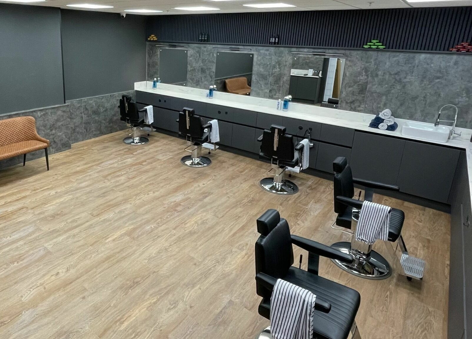 Interior of Gould Barbers Colchester showcasing sleek barber chairs and modern design in Colchester, England, GB.