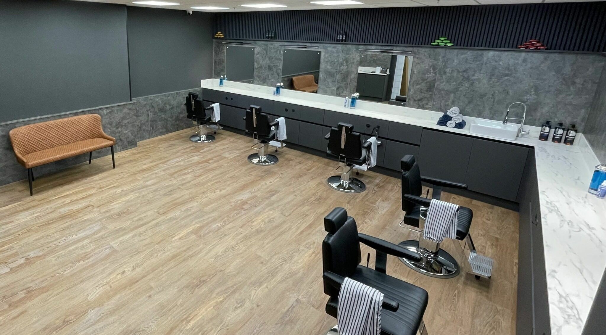 Interior of Gould Barbers Colchester showcasing sleek barber chairs and modern design in Colchester, England, GB.