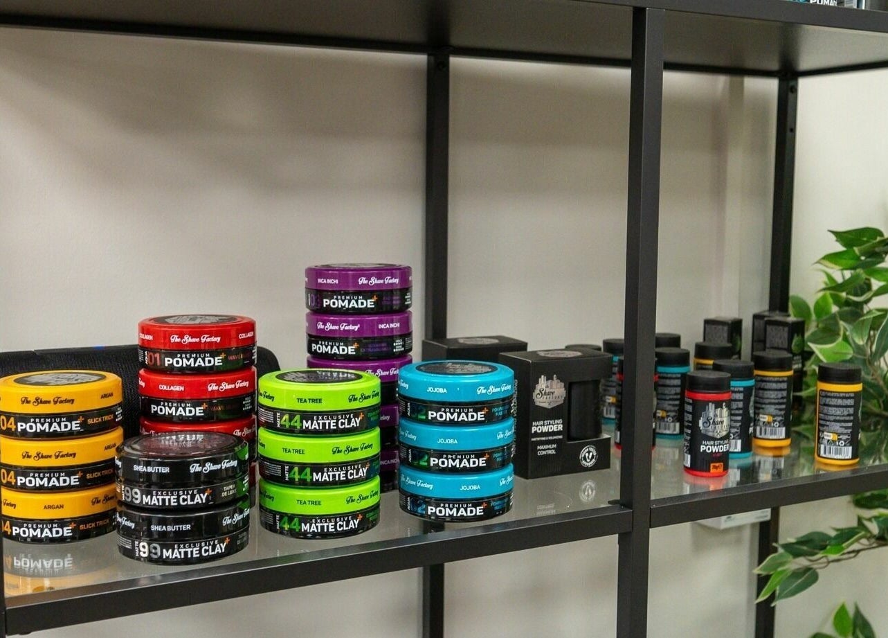 Colorful pomade display at Gould Barbers Colchester, Colchester, England, GB, showcasing premium hair products.