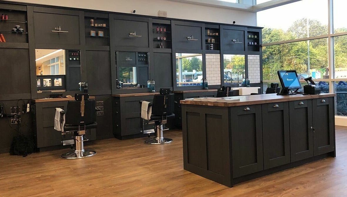 Interior of Gould Barbers Warwick, showcasing sleek workstations in Warwick, England, GB.