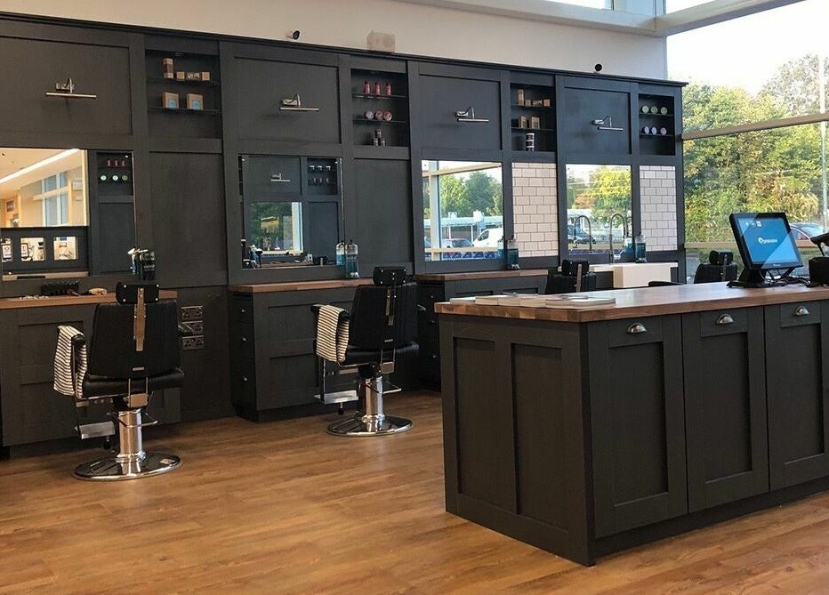 Interior of Gould Barbers Warwick, showcasing sleek workstations in Warwick, England, GB.