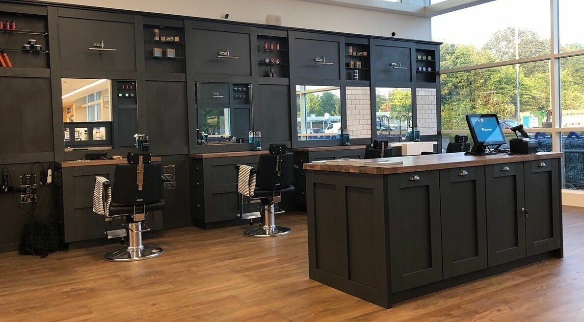 Interior of Gould Barbers Warwick, showcasing sleek workstations in Warwick, England, GB.