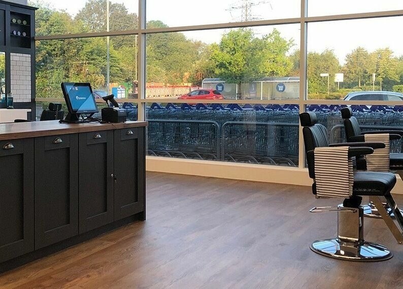 Interior of Gould Barbers Warwick in Warwick, England, GB with modern chairs and spacious design.