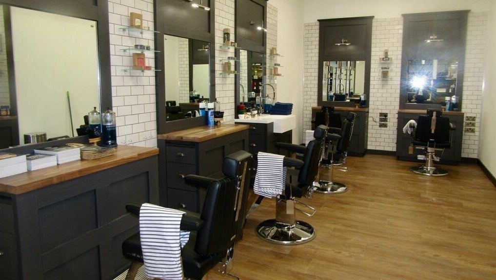 Chic interior of Gould Barbers Hatfield with sleek chairs and mirrors, Hatfield, England, GB.