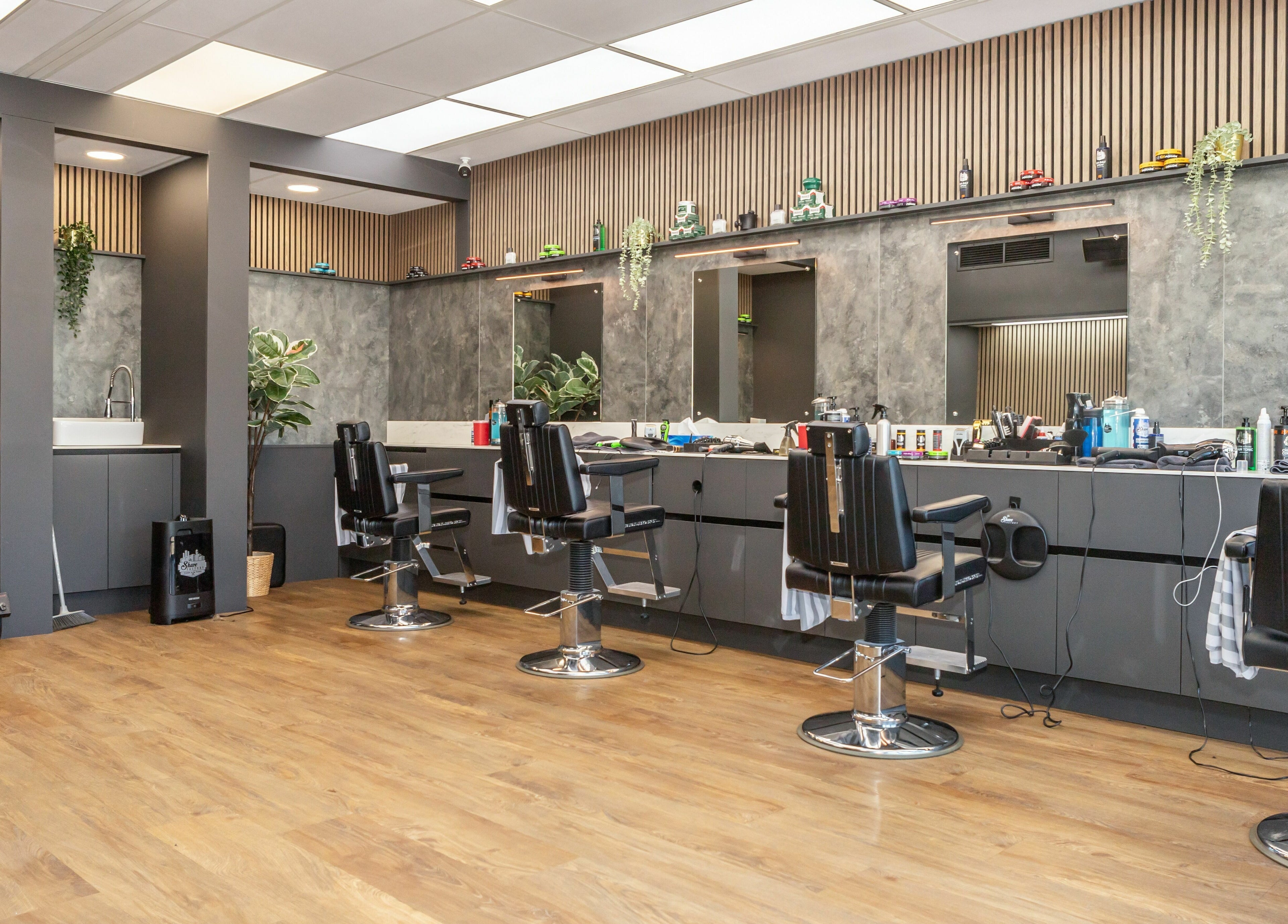 Modern interior of Gould Barbers Lakeside in Lakeside, England, GB showcasing sleek barber chairs and styling stations.