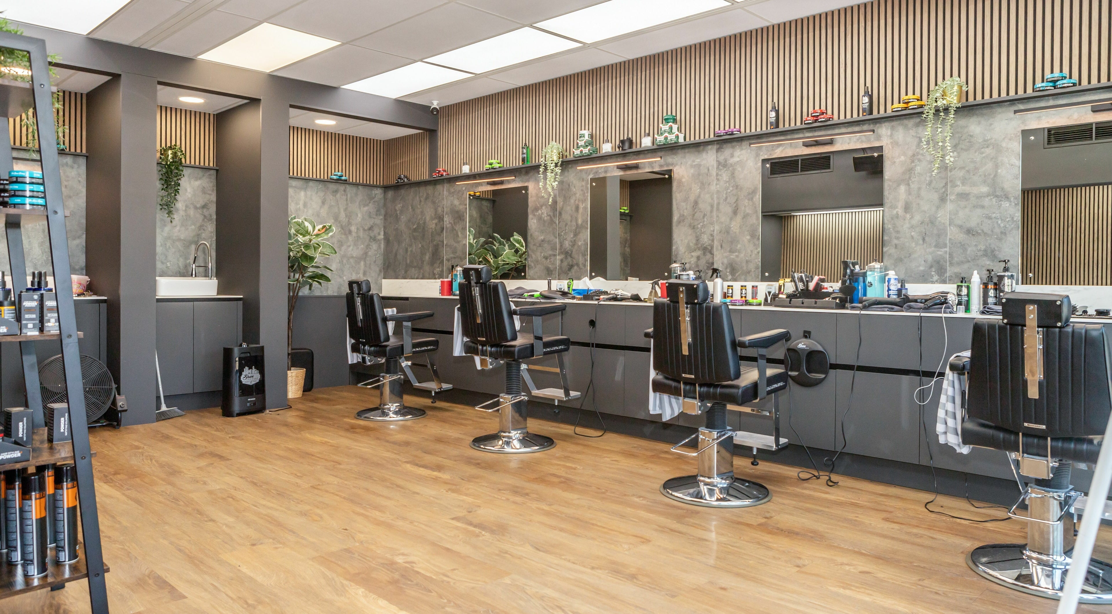 Modern interior of Gould Barbers Lakeside in Lakeside, England, GB showcasing sleek barber chairs and styling stations.