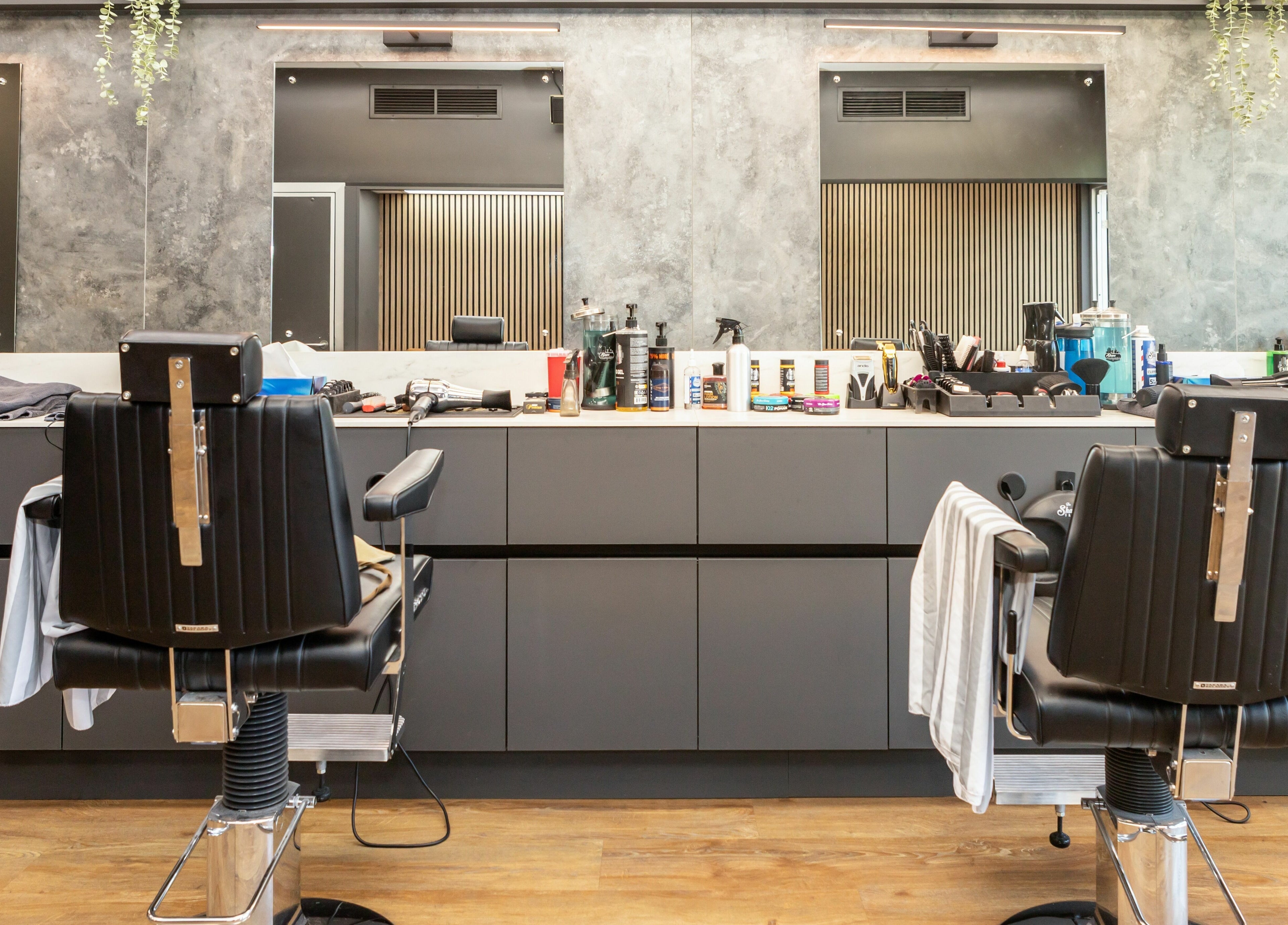 Modern barber chairs at Gould Barbers Lakeside, Lakeside, England, GB, showcasing a sleek and professional setting.