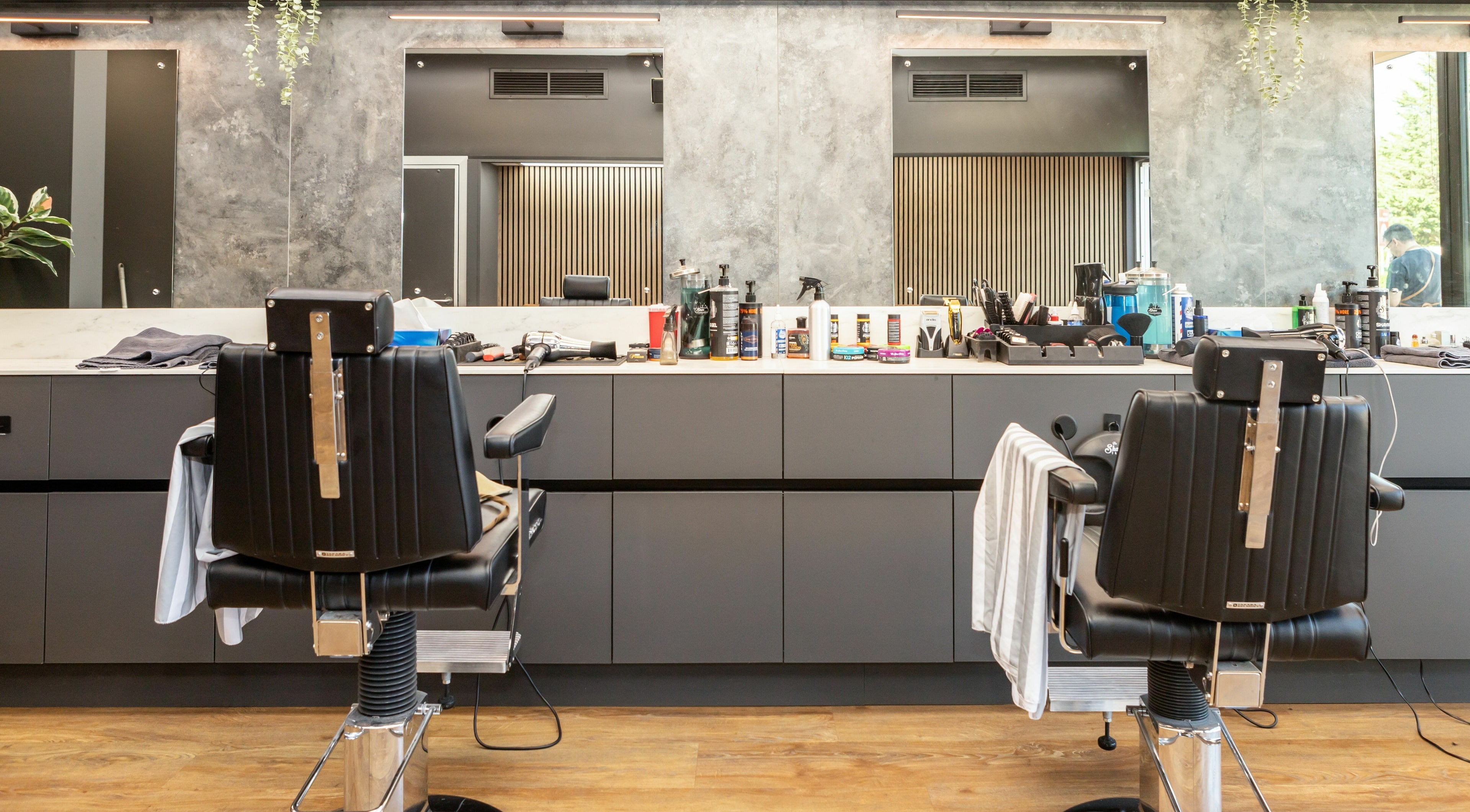 Modern barber chairs at Gould Barbers Lakeside, Lakeside, England, GB, showcasing a sleek and professional setting.