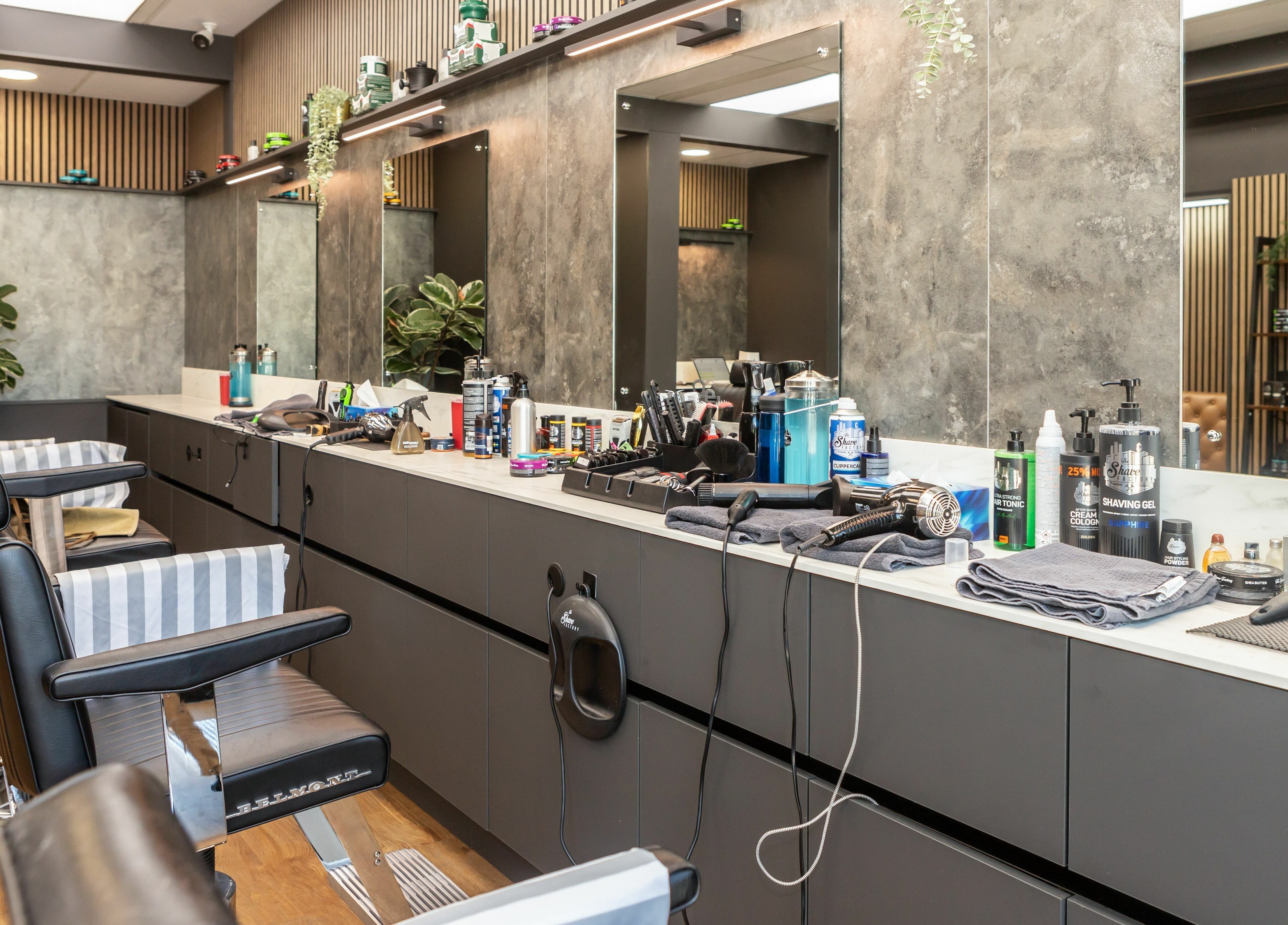 Stylish interior of Gould Barbers Lakeside in Lakeside, England, GB showcasing barber chairs and grooming tools.