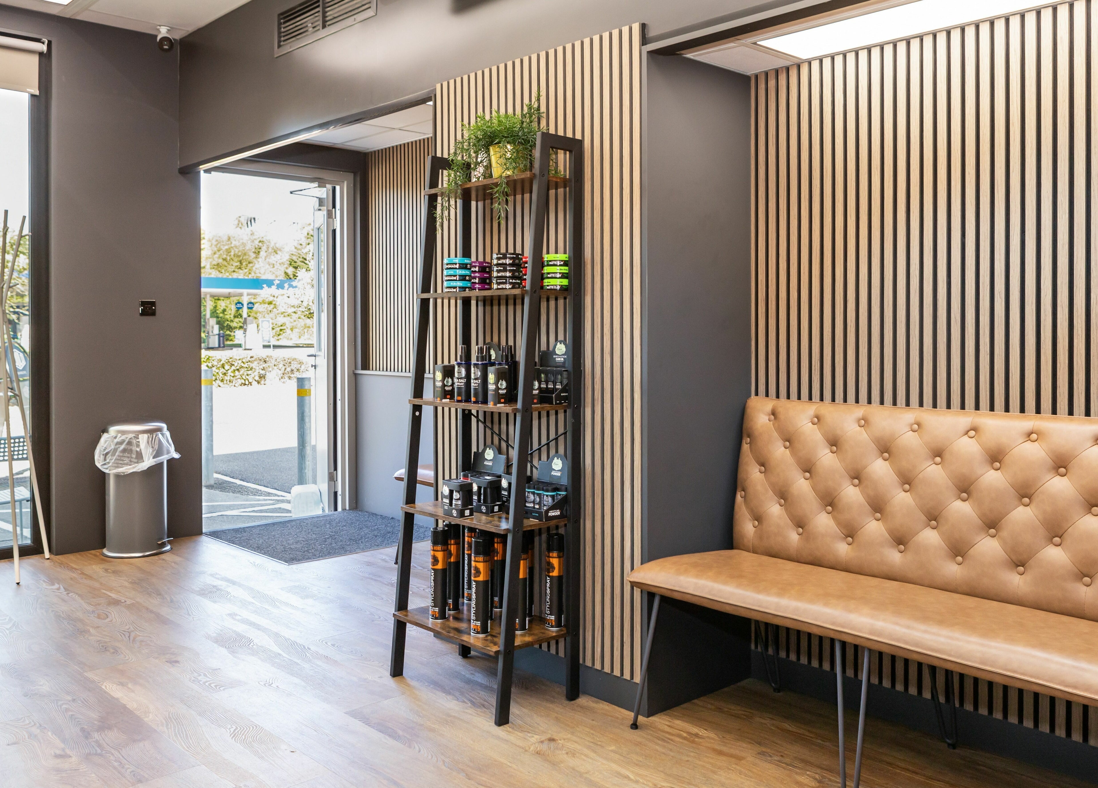 Elegant Gould Barbers Lakeside interior with leather seating and stocked shelves, Lakeside, England, GB.