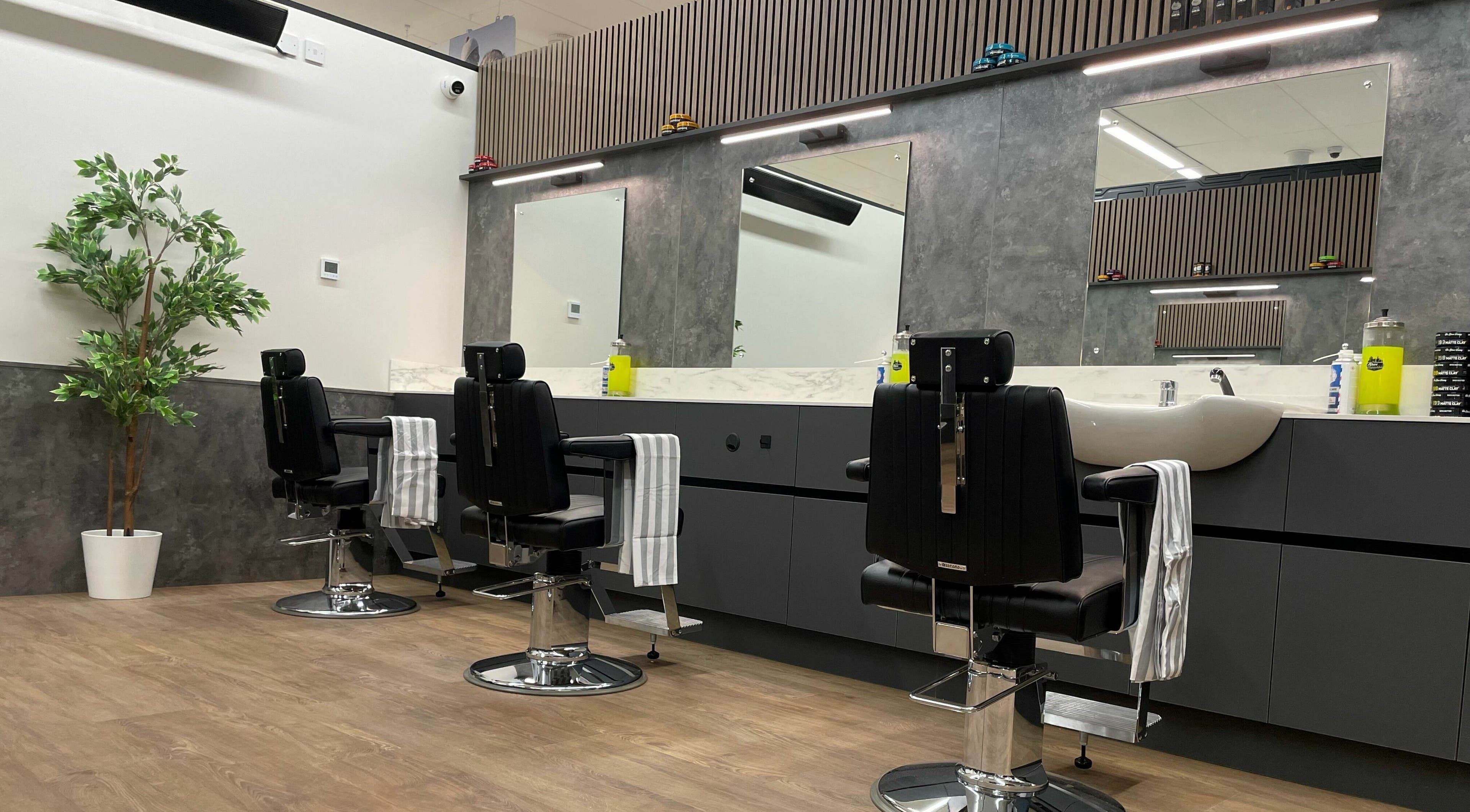 Modern barber chairs at Gould Barbers Sheffield, Sheffield, England, GB with mirrors and stylish decor.