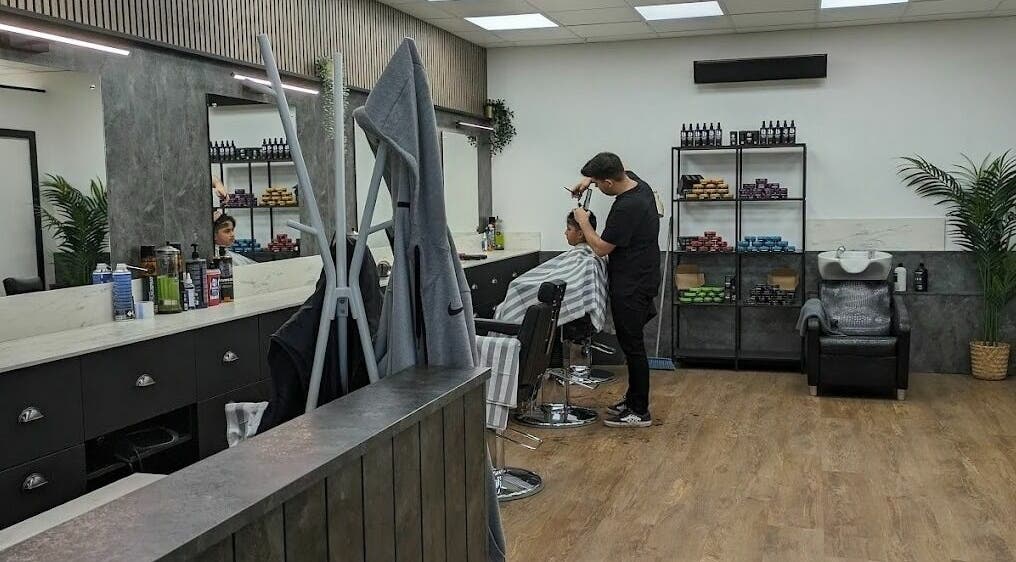 Interior of Gould Barbers Sheffield, Sheffield, England, GB, showcasing a stylist working with a customer.