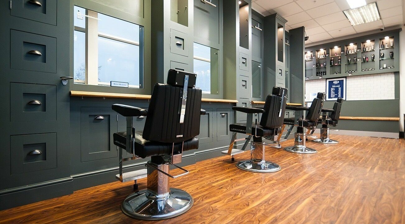 Modern barber chairs at Gould Barbers Wisbech, Wisbech, England, GB, showcasing sleek design and comfort.